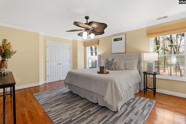 bedroom with visible vents, light wood finished floors, and multiple windows