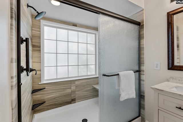 full bath with an enclosed shower and vanity