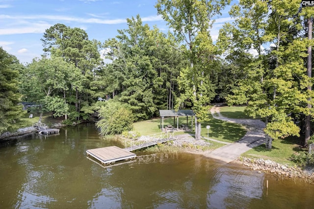 dock area featuring a lawn and a water view