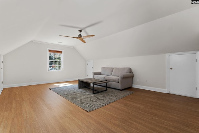 additional living space with a ceiling fan, vaulted ceiling, baseboards, and wood finished floors