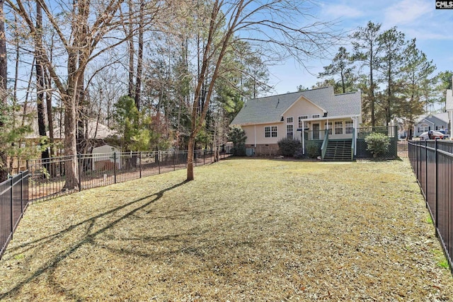 view of yard featuring a fenced backyard, stairway, and a wooden deck