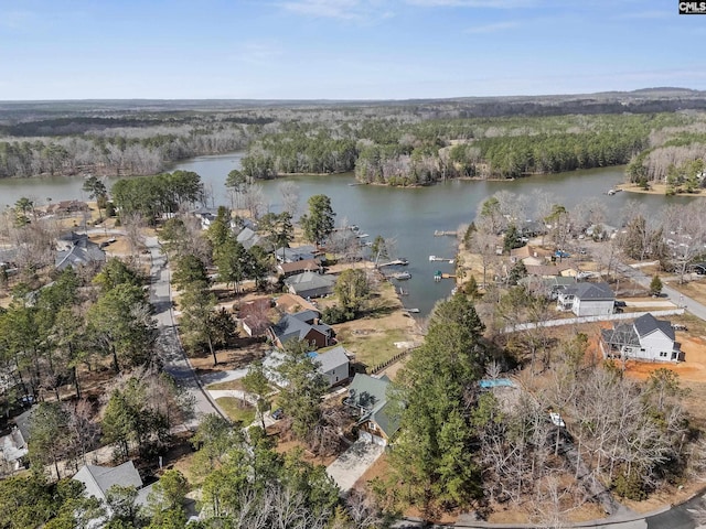 aerial view with a water view and a wooded view