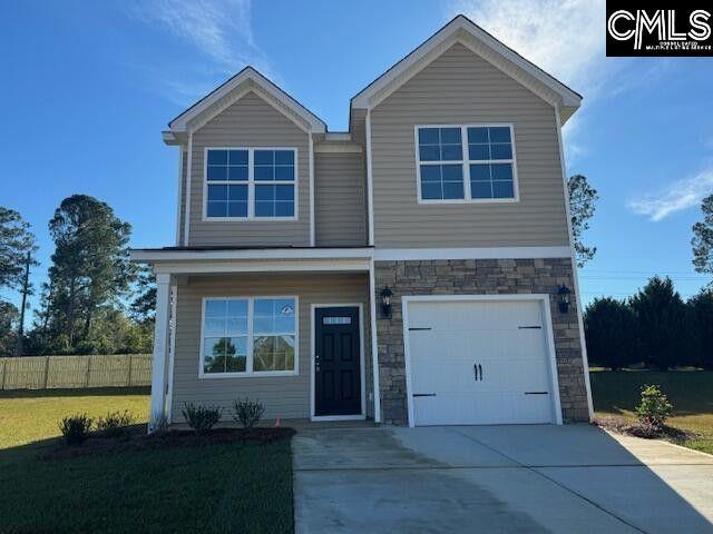 traditional-style home featuring an attached garage, fence, driveway, stone siding, and a front yard