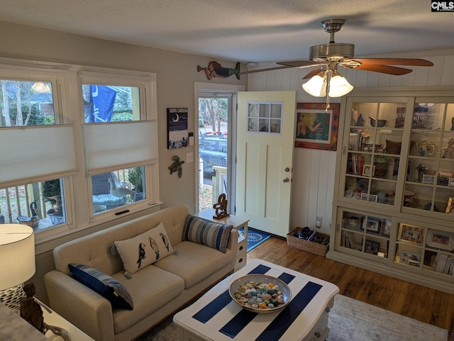 living room featuring a textured ceiling and wood finished floors