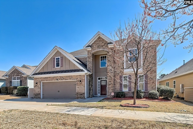 view of front of home with a standing seam roof, board and batten siding, concrete driveway, metal roof, and brick siding