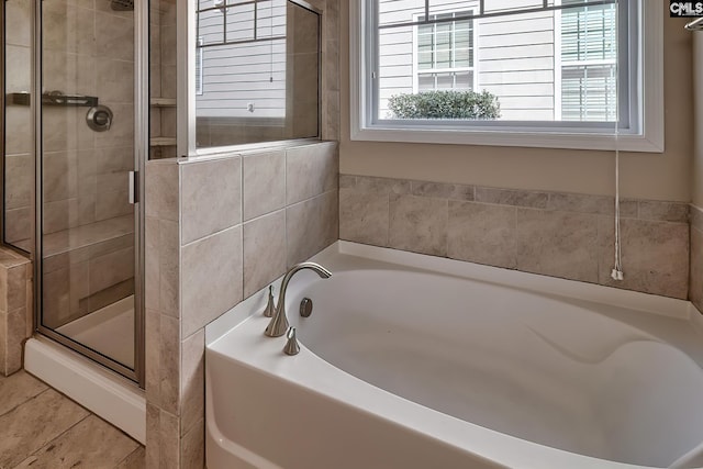 bathroom with a garden tub and a stall shower