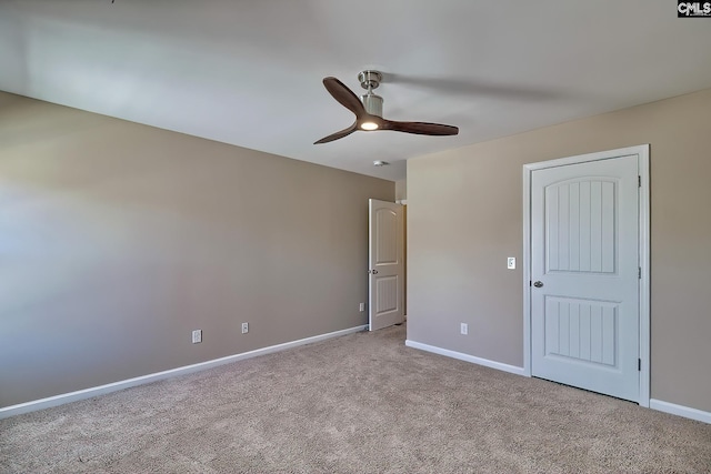 unfurnished bedroom featuring baseboards, carpet, and a ceiling fan