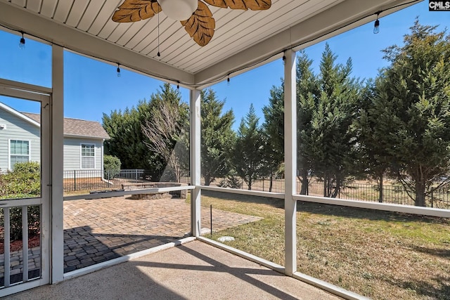 unfurnished sunroom with a ceiling fan