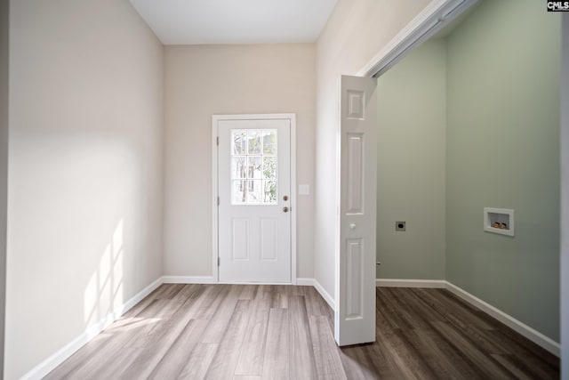 foyer with wood finished floors and baseboards