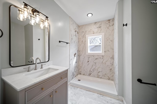 bathroom featuring a stall shower, marble finish floor, and vanity