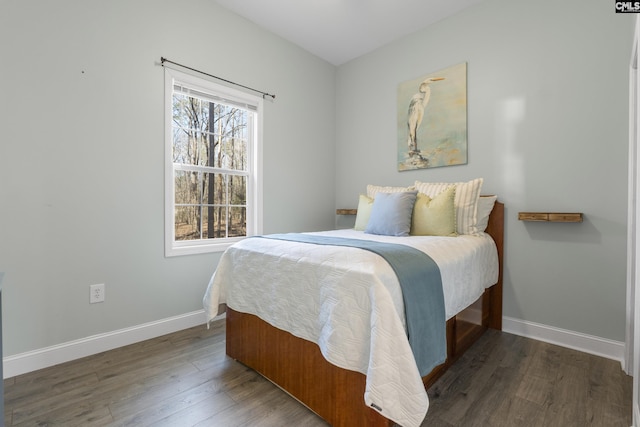 bedroom with baseboards and wood finished floors