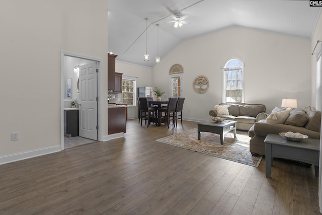 living room with high vaulted ceiling, dark wood-type flooring, a wealth of natural light, and a ceiling fan