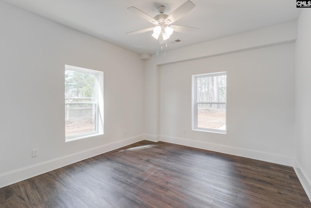 unfurnished room featuring ceiling fan, dark wood-style flooring, visible vents, and baseboards