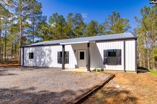 modern inspired farmhouse with metal roof and board and batten siding