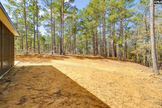 view of yard with a wooded view