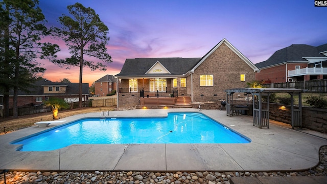 view of pool with a patio, fence, a diving board, a fenced in pool, and a pergola