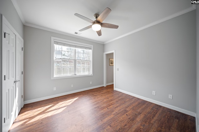 unfurnished bedroom with ceiling fan, wood finished floors, visible vents, baseboards, and crown molding