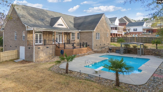 view of swimming pool featuring french doors, a fenced backyard, a patio, and a pergola