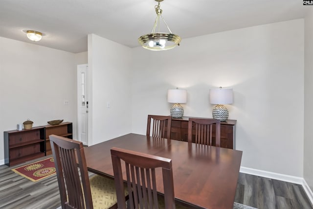 dining room featuring baseboards and wood finished floors