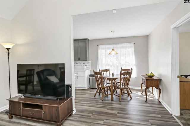 dining room featuring dark wood-type flooring and baseboards