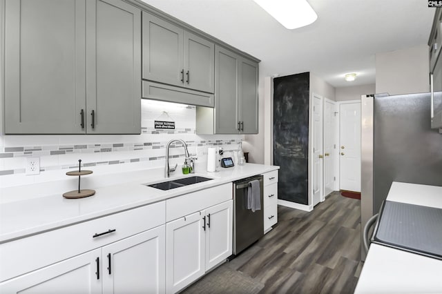 kitchen featuring a sink, backsplash, light countertops, and stainless steel dishwasher