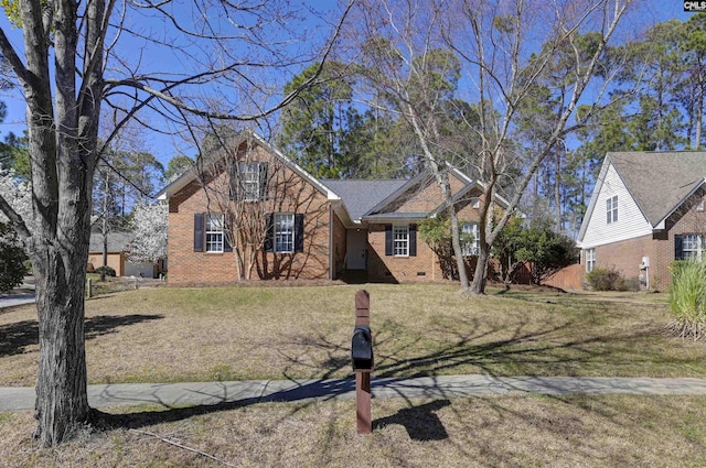 view of front of property with crawl space, a front lawn, and brick siding