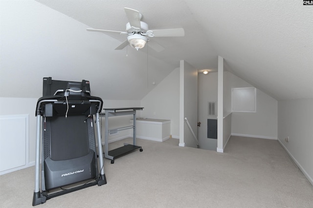 workout room featuring lofted ceiling, ceiling fan, carpet flooring, and visible vents