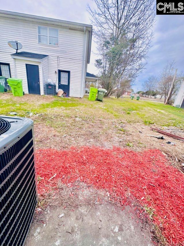 view of yard featuring central air condition unit