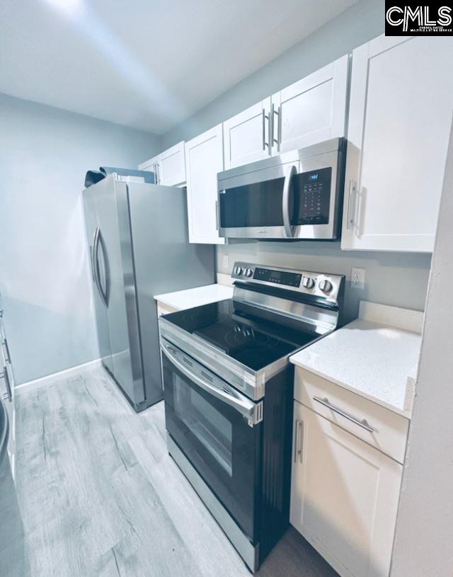 kitchen featuring white cabinetry, appliances with stainless steel finishes, and light countertops