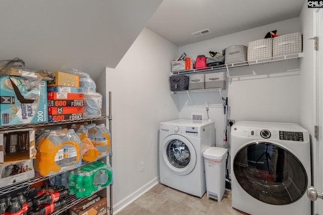 laundry room featuring laundry area, visible vents, washer and clothes dryer, and baseboards