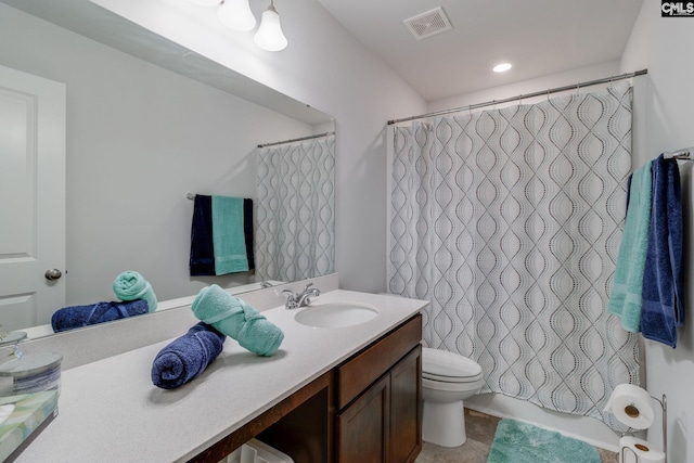 full bath with toilet, vanity, and visible vents