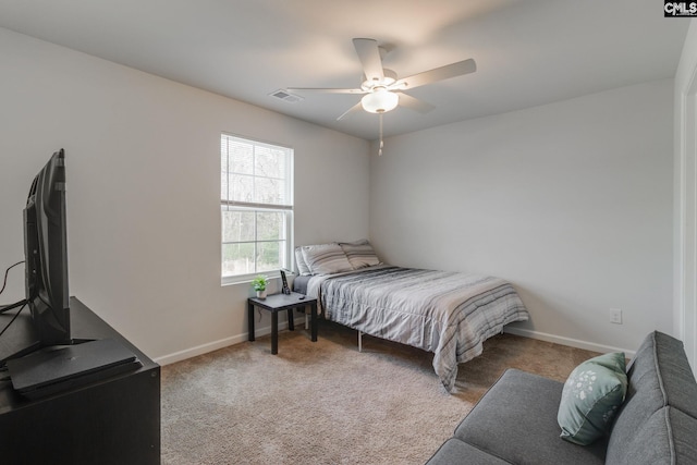 carpeted bedroom featuring ceiling fan, visible vents, and baseboards