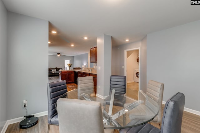 dining room with baseboards, washer / clothes dryer, light wood-type flooring, and recessed lighting