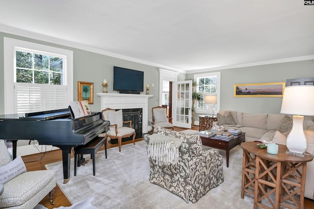 living room with ornamental molding and a glass covered fireplace