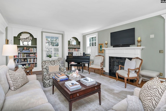 living room with plenty of natural light, ornamental molding, and a glass covered fireplace