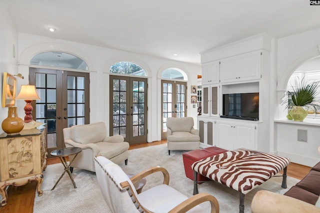 living area featuring light wood-type flooring, french doors, and recessed lighting