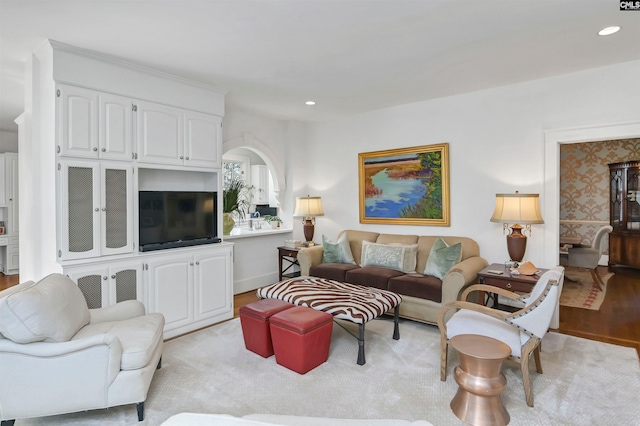 living area with light wood-type flooring and recessed lighting