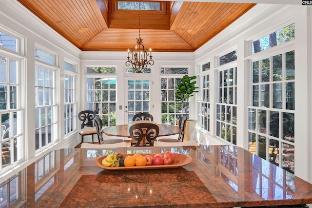 sunroom / solarium with wood ceiling, vaulted ceiling, and an inviting chandelier