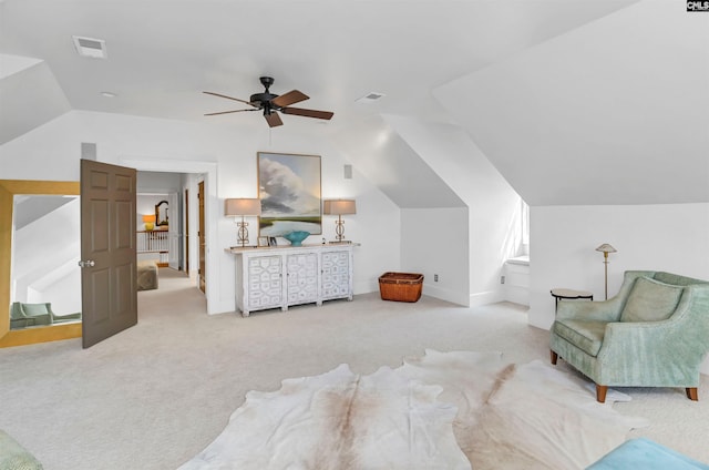 sitting room with carpet, visible vents, and vaulted ceiling