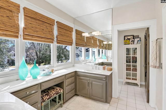 interior space with light tile patterned floors and a sink