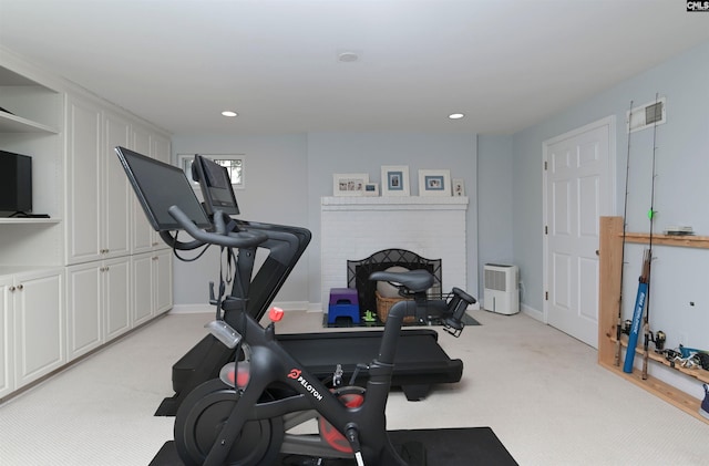 workout area featuring recessed lighting, baseboards, and light colored carpet