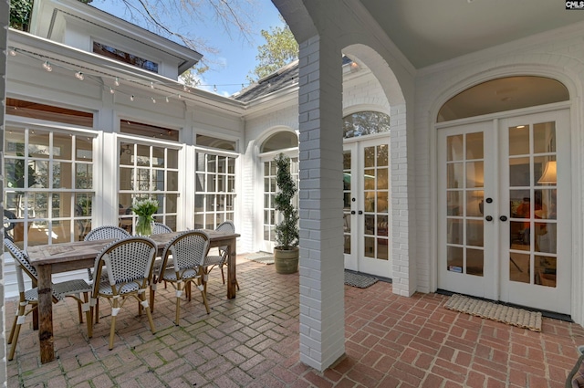 sunroom / solarium featuring french doors