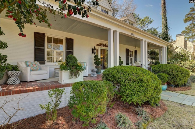 view of side of property with covered porch