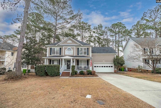 view of front of home featuring a front yard, covered porch, driveway, and an attached garage