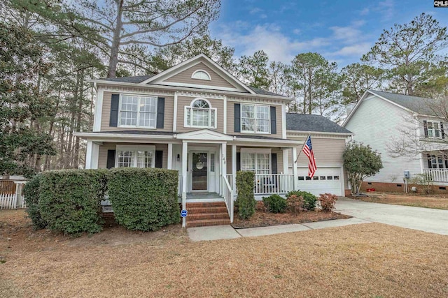 view of front of home featuring a garage, concrete driveway, and a porch