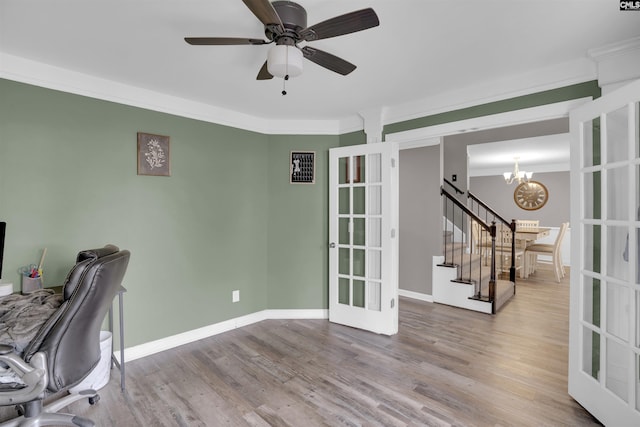 office area with ceiling fan with notable chandelier, baseboards, crown molding, and wood finished floors