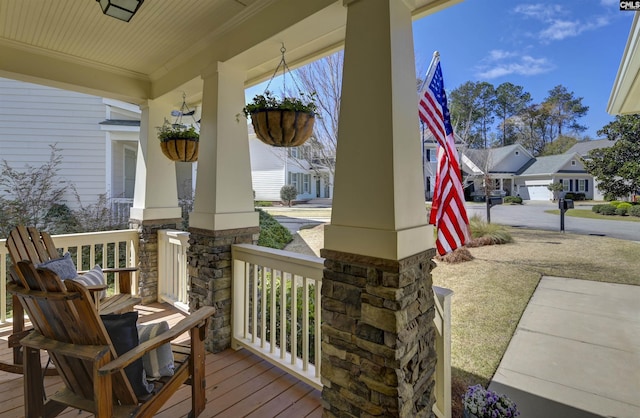 wooden terrace with covered porch and a residential view