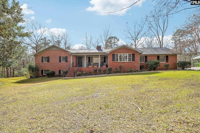 single story home with covered porch, brick siding, a chimney, and a front yard