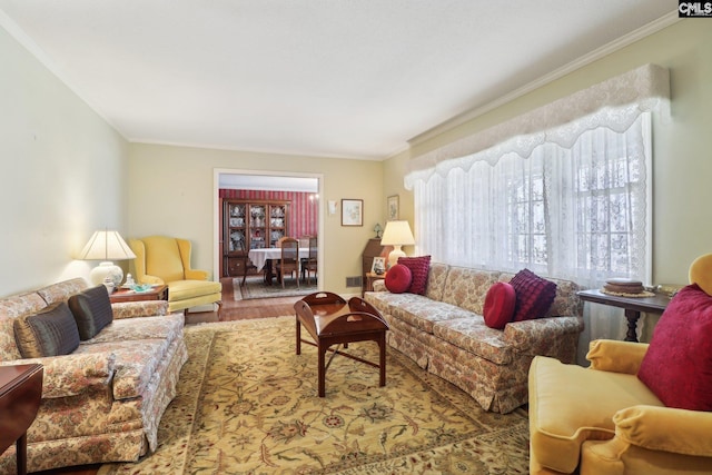 living area featuring wood finished floors and crown molding