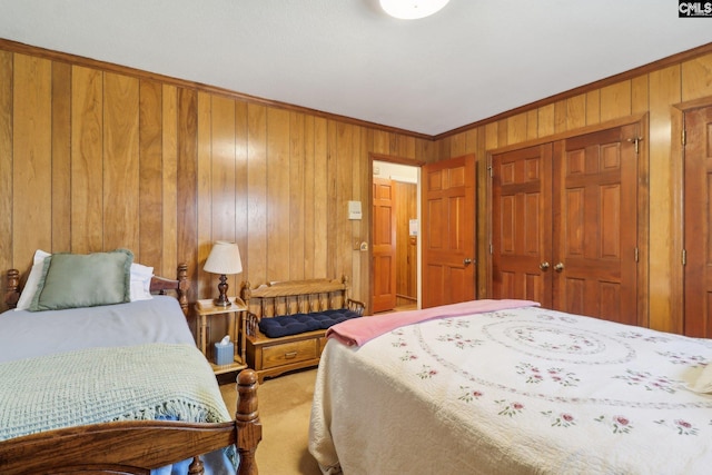 carpeted bedroom featuring crown molding, a closet, and wood walls